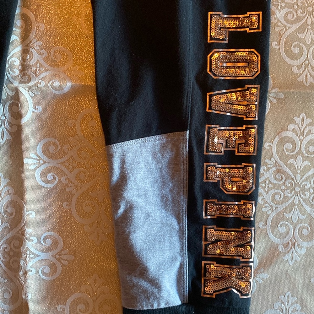 Sequins on leg with rose gold letters. Washed twice. Great New condition
